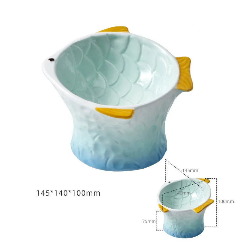 Blue fish-shaped ceramic elevated cat bowl with tilted design on a non-slip base.