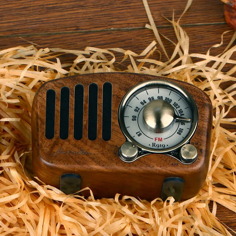 Retro wooden wireless mini speaker in cherry wood finish showing front grille and compact size
