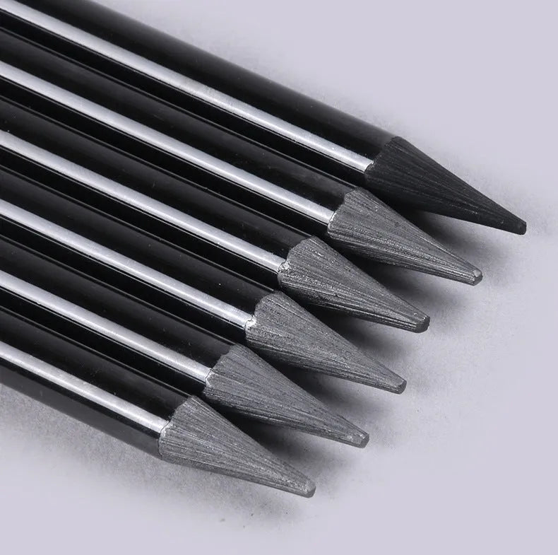 Set of nine wooden drawing pencils on a card, including graphite and carbonized pencils for sketching.