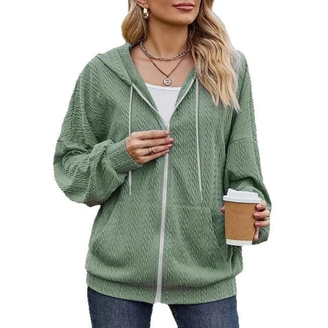 Green women's hooded zipper sweater jacket laid flat, showing casual loose fit and long sleeves.