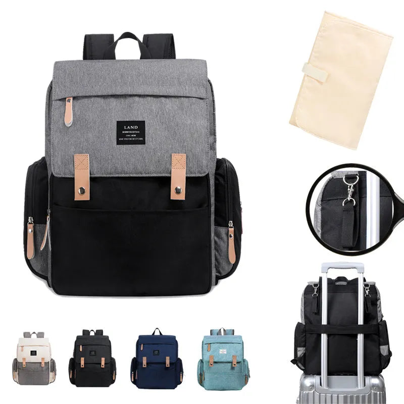 LAND Mommy large grey Oxford cloth diaper backpack with changing mat, showing front compartments.