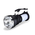 Black solar-powered LED flashlight with USB charging port shown on a textured background.