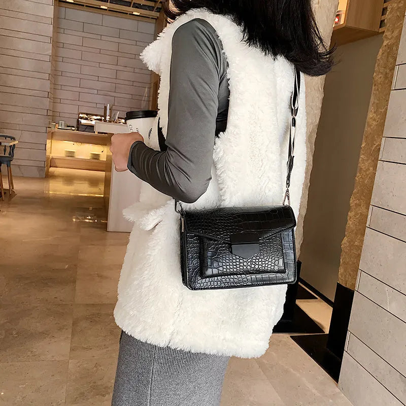 Vintage-style black PU leather crossbody bag with dimensions 20cm by 14cm by 7cm.