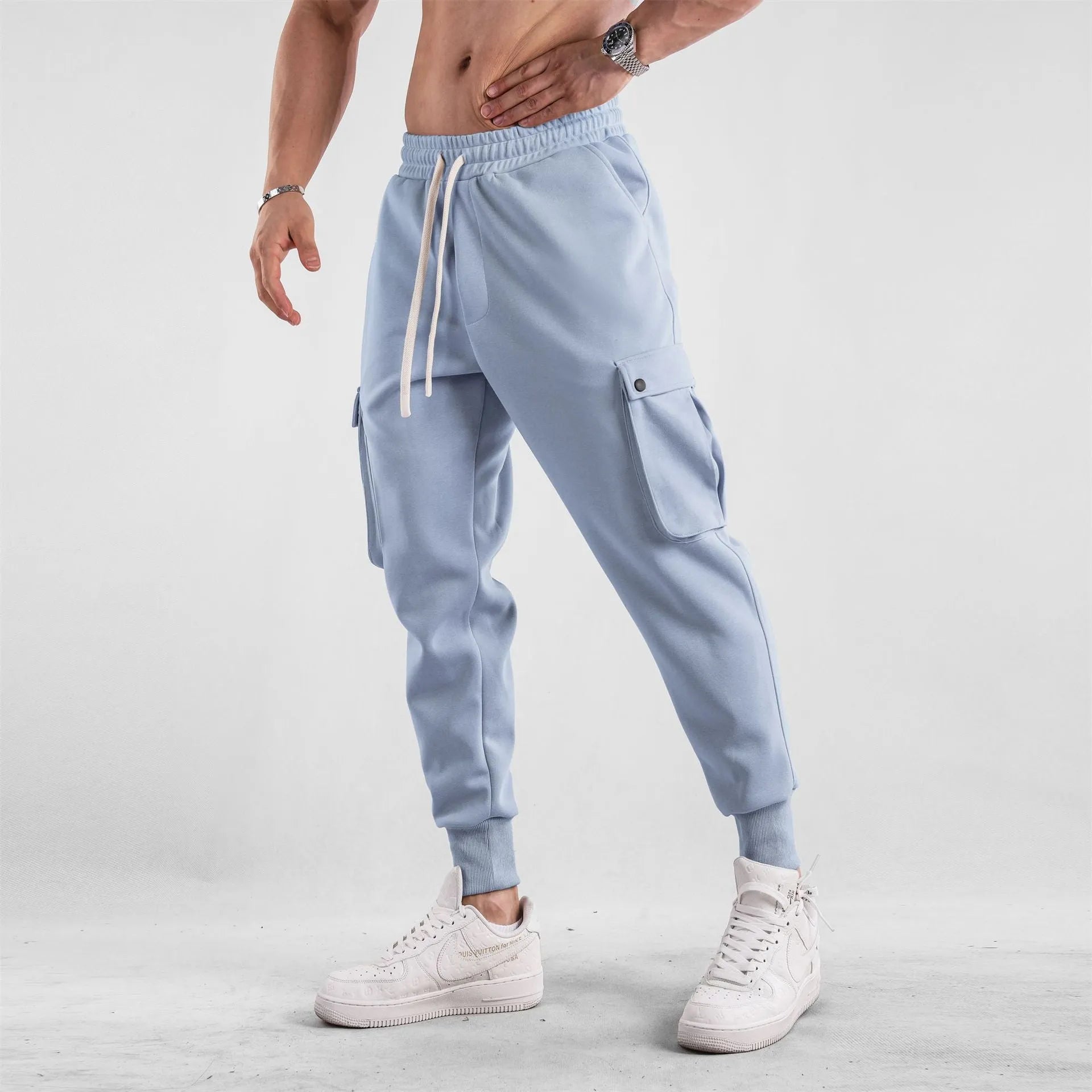Men's loose light gray cotton trousers with ankle-tied cuffs and multiple pockets