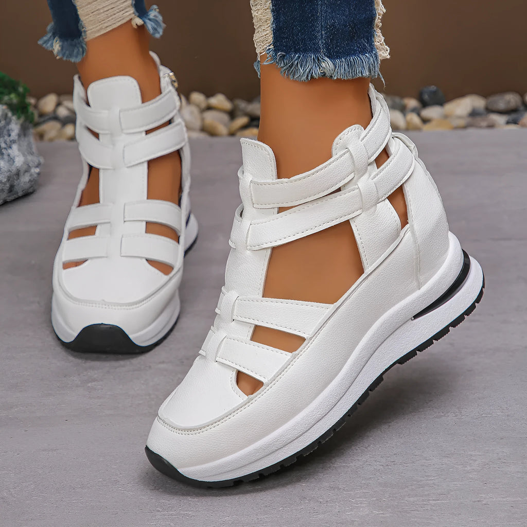 Women's black close-toed hollow-out platform sandals with a Velcro strap on a white background.