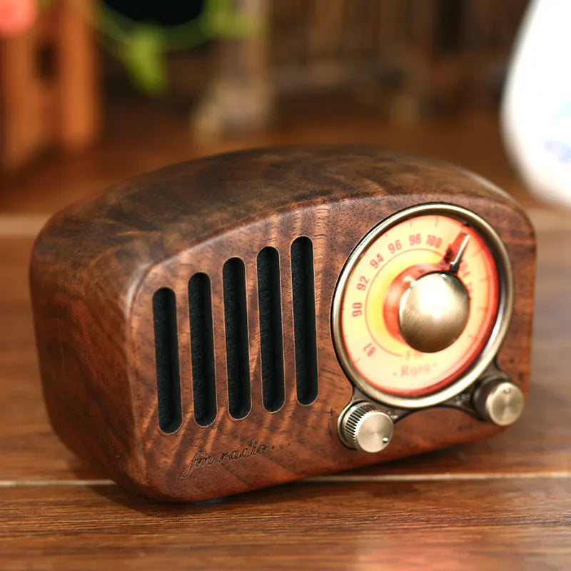Retro wooden wireless mini speaker in cherry wood finish showing front grille and compact size