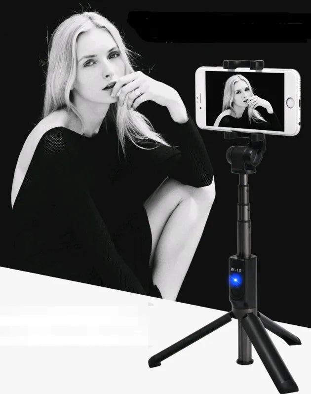 Aluminium alloy Bluetooth tripod selfie stick with remote control extended, holding a mobile phone.