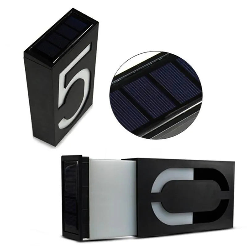Solar powered house number light with 6 LEDs and IP65 waterproof rating mounted on an exterior wall.