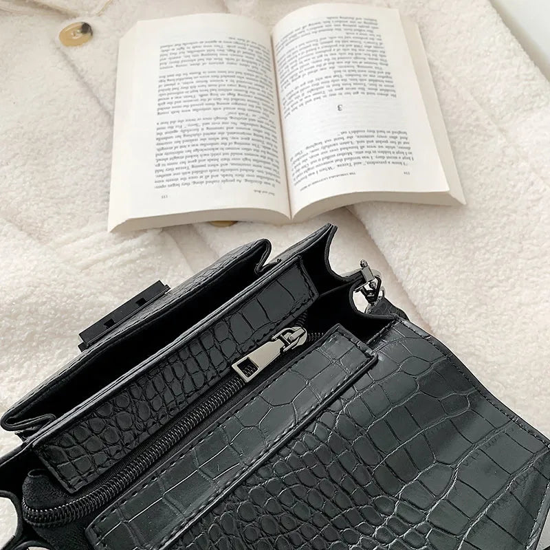Vintage-style black PU leather crossbody bag with dimensions 20cm by 14cm by 7cm.