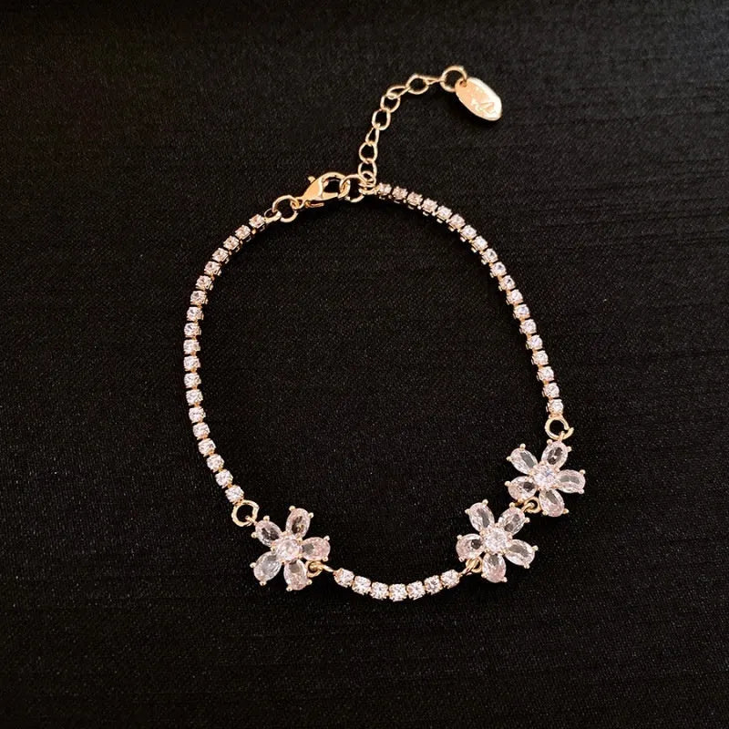 Gold tone geometric women's bracelet with quadrilateral design and inlaid zircon stones on copper base