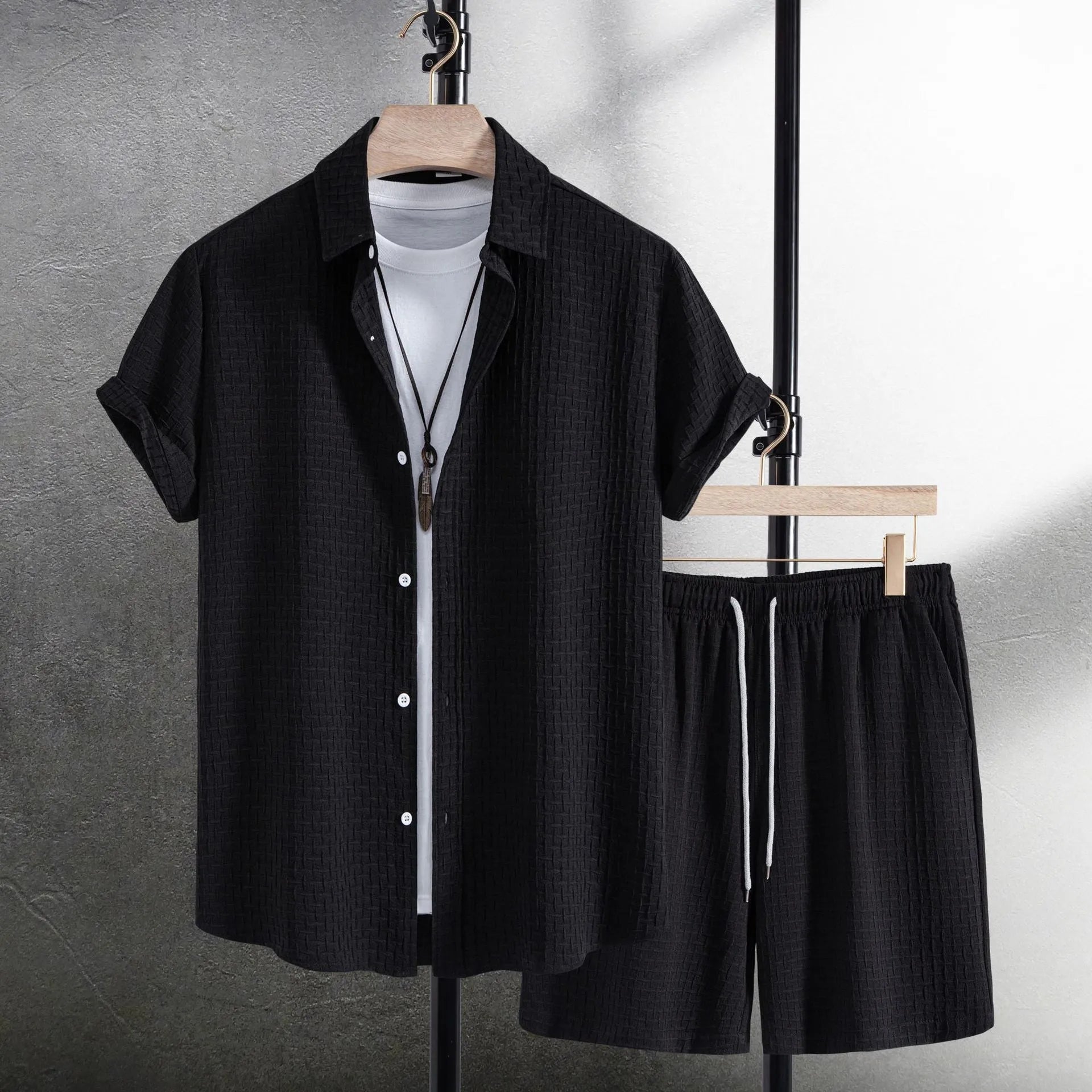Men's black cotton blend short sleeve shirt and shorts casual suit set on a hanger.