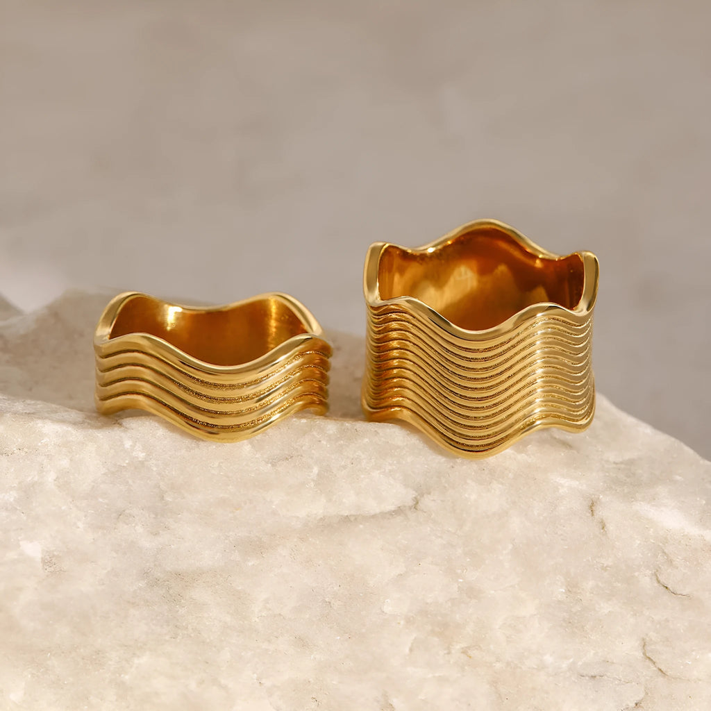 Stainless steel women's ring with geometric wide wave design and electroplated finish.