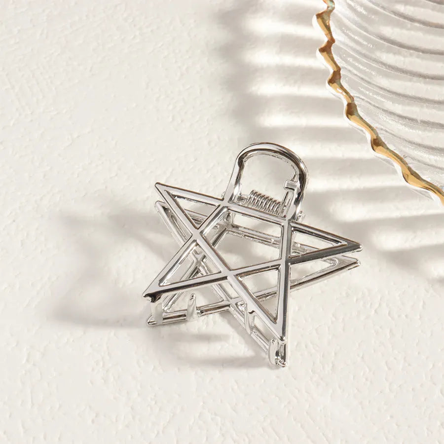 Silver metal hair claw clip assortment showing bows, waves, pearl designs, and geometric shapes from 4cm to 13.5cm