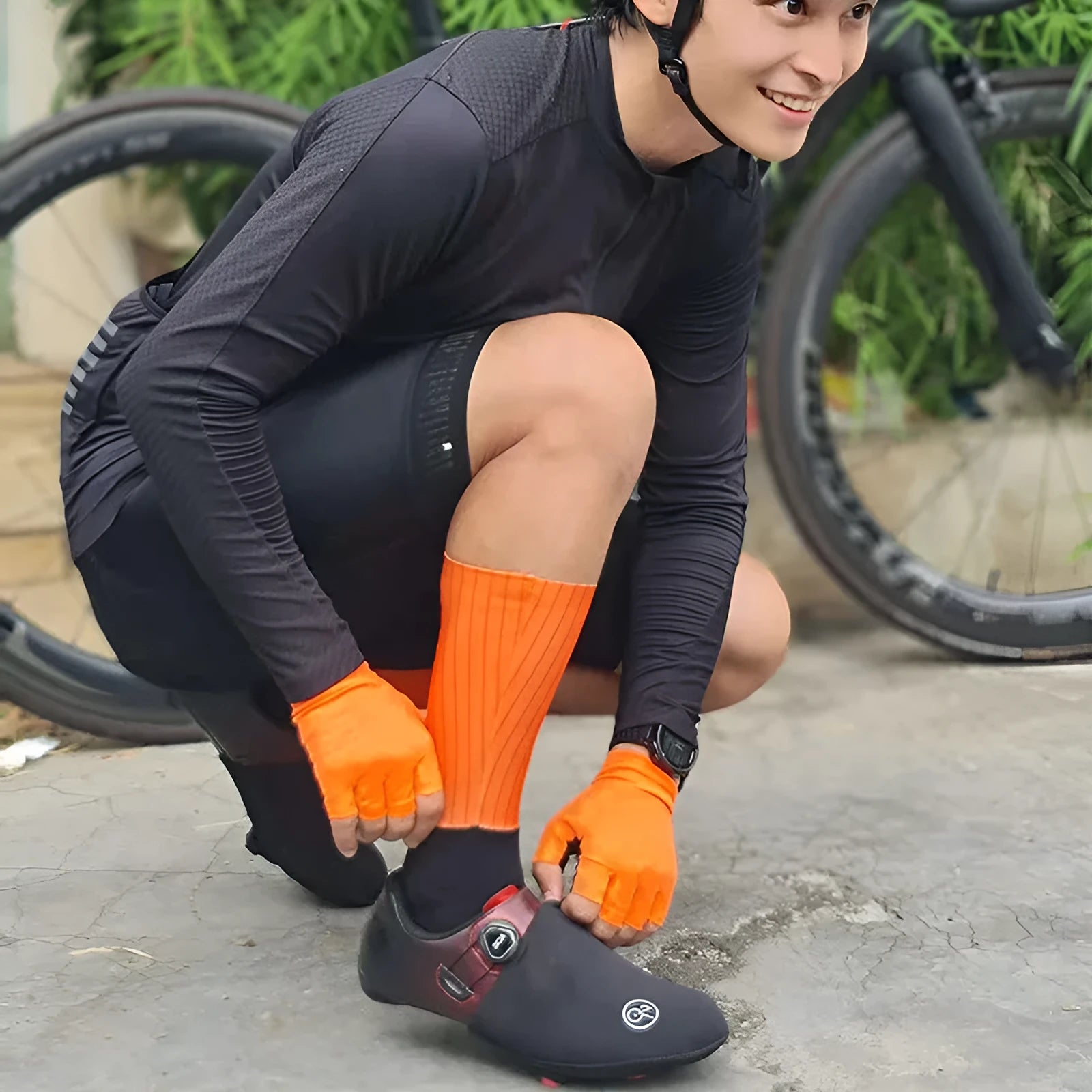 Pair of breathable athletic socks for running and cycling in orange colour on a grey background