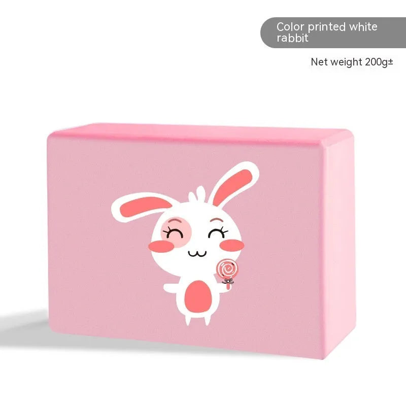 High-density EVA yoga block in violet colour next to a pink block with a cartoon print design.