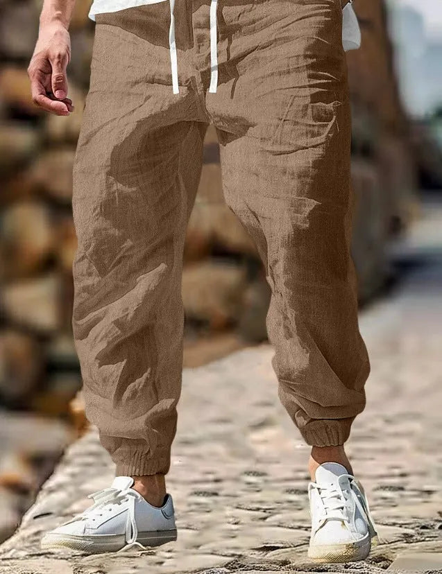 Men's straight-leg linen trousers in apricot colour with an elasticated waistband.