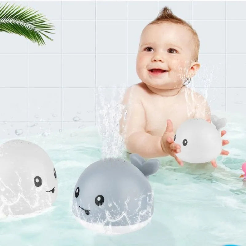 White and blue whale-shaped electric bath toy with water spray fountain and LED lights