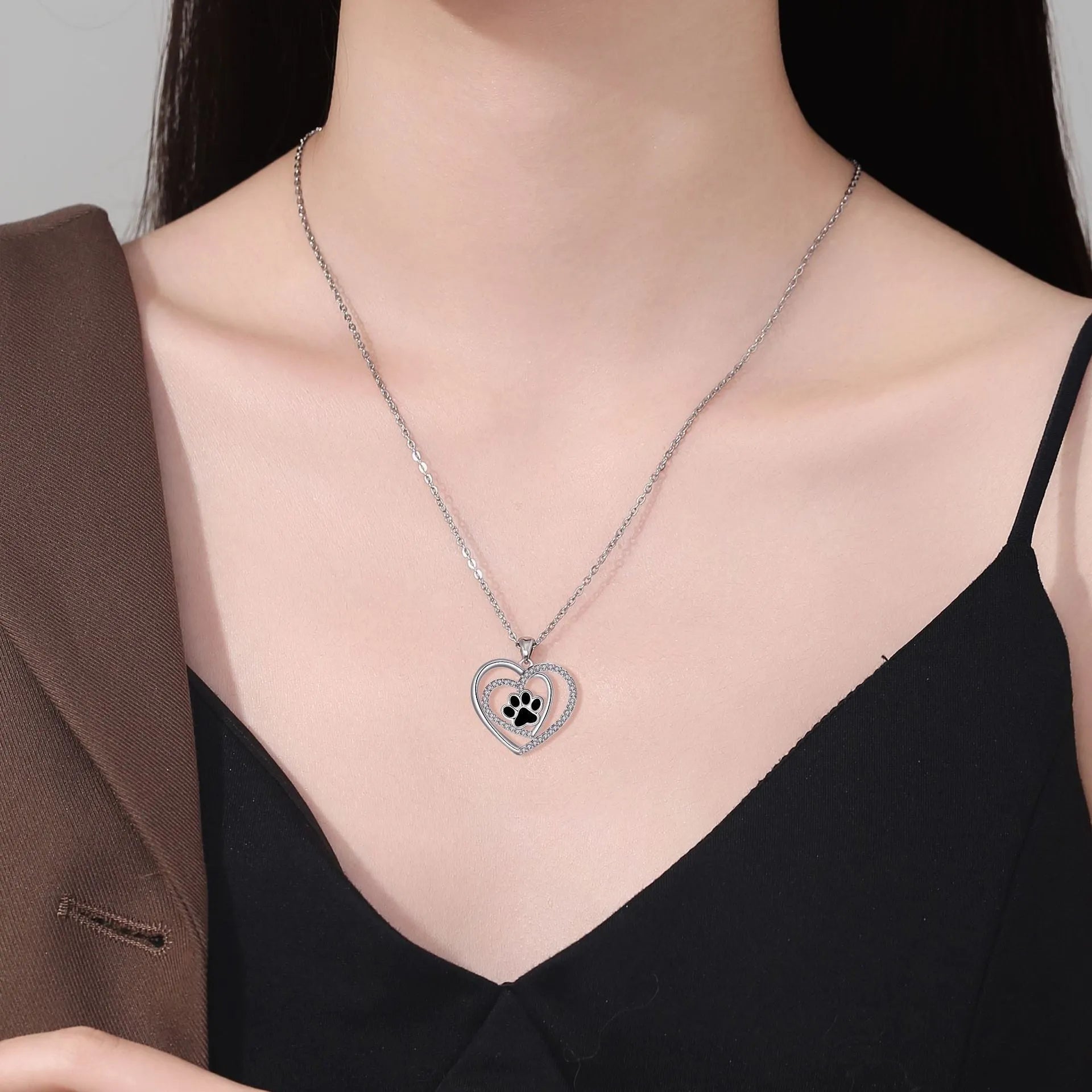 Women's copper necklace with heart-shaped dog paw print pendant on a cross chain