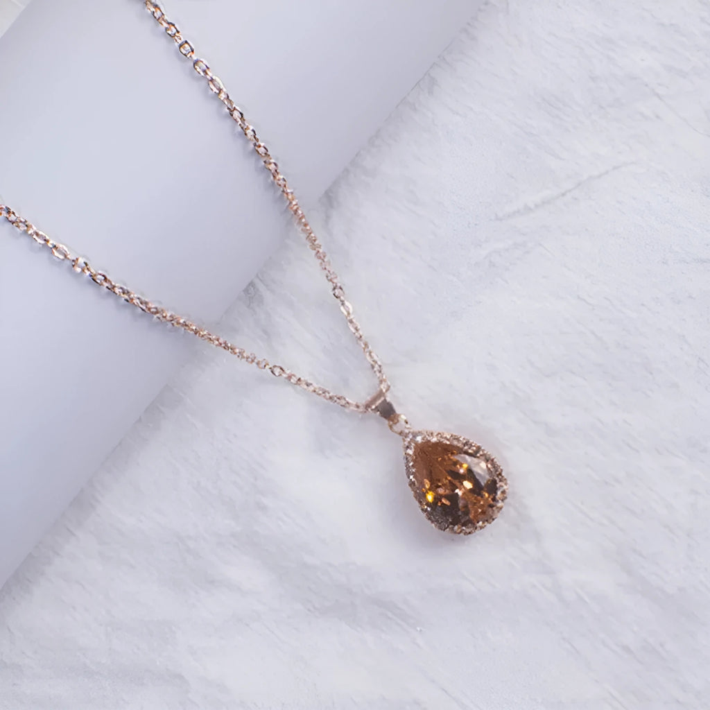 Rose gold pink drop shape women's necklace with geometric rhinestone detailing and alloy construction