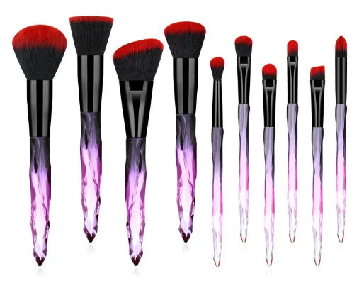Ten clear crystal diamond shank foundation brushes with artificial fibre heads, shown in a set.
