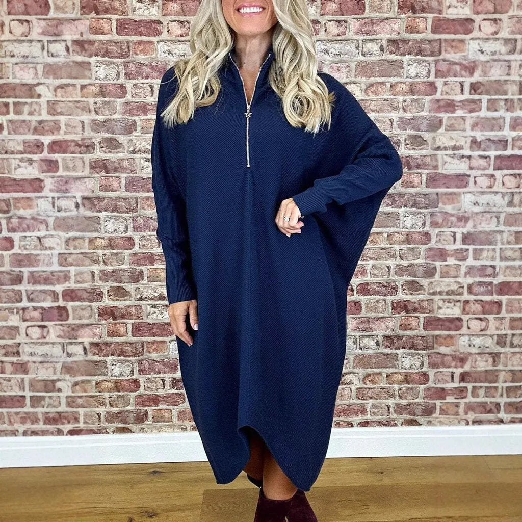 Women's loose-fit knitted dress in navy blue with a front zip closure and raglan sleeves.