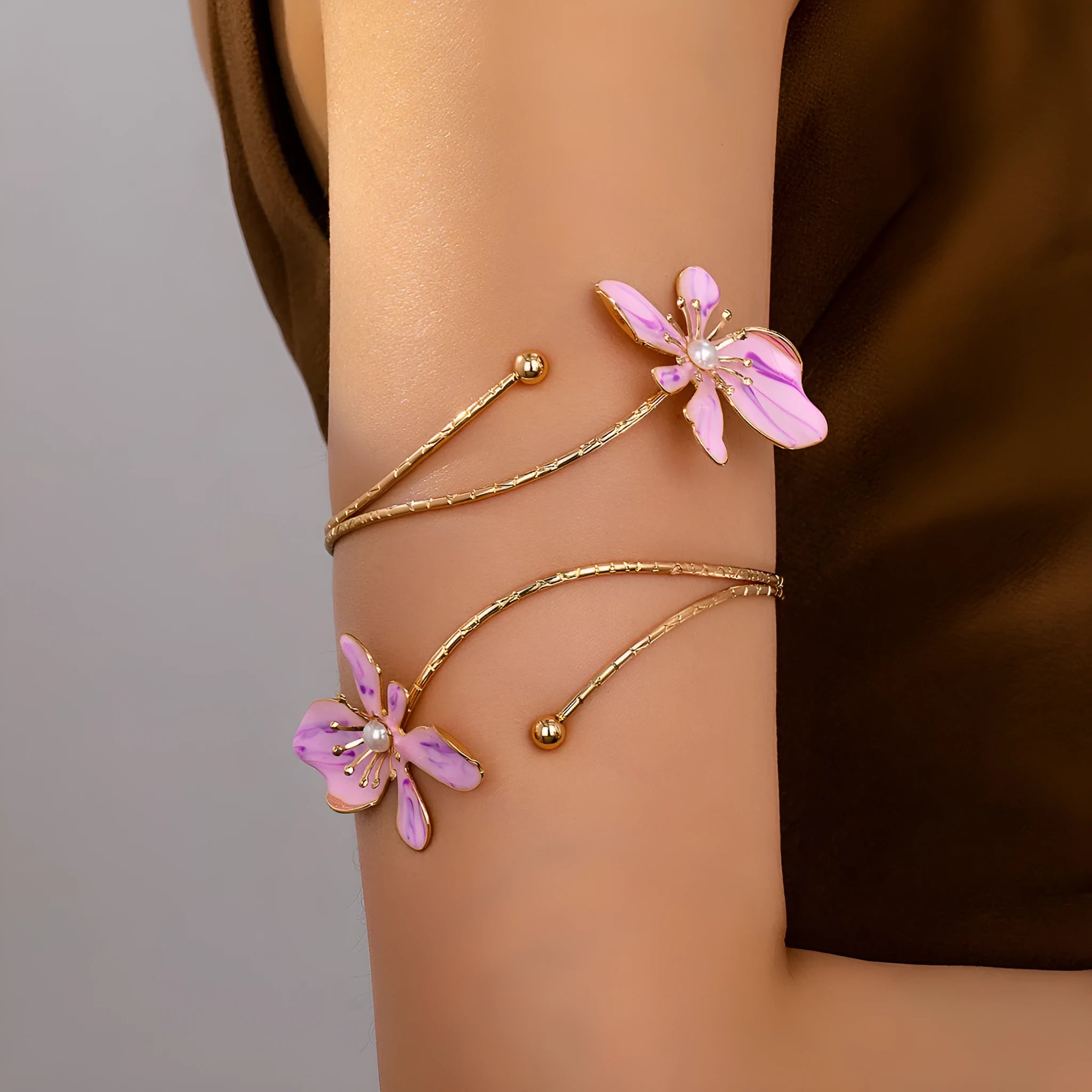 Pink alloy armband with hollow line pattern design on wrist