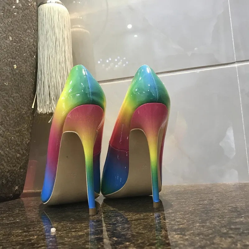 Rainbow coloured patent leather women's high heel shoe with pointed toe and thin high heel.