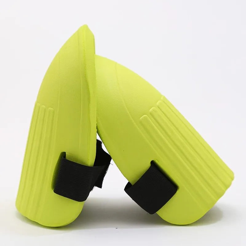 A pair of black EVA foam knee pads for gardening, showing their rectangular shape and textured surface.