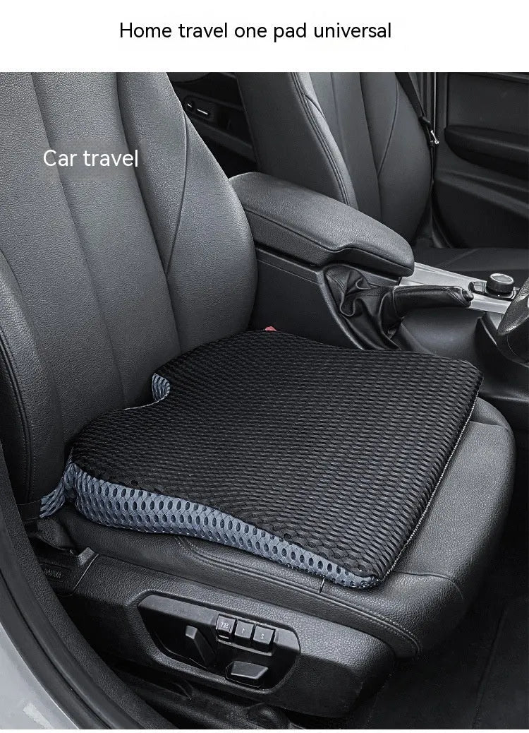 Solid colour memory foam cushion with an attached strap, shown on a car seat.