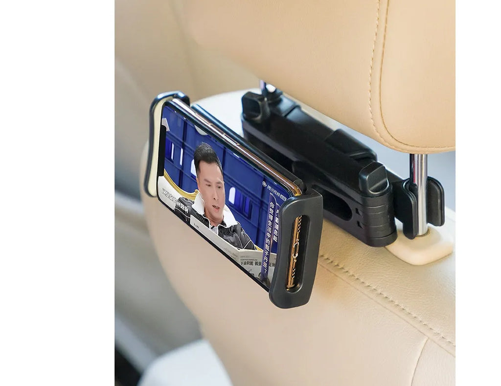 Black car phone holder mounted on vehicle rear seat base holding tablet for navigation