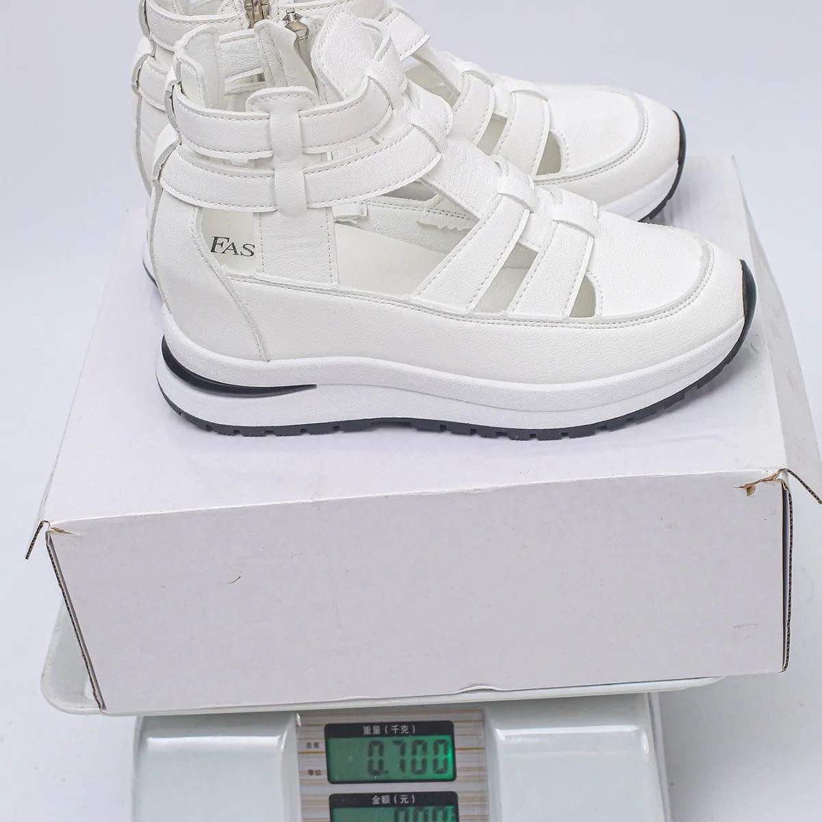 Women's black close-toed hollow-out platform sandals with a Velcro strap on a white background.