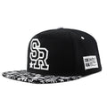Cotton baseball hat with embroidered letters on a dome crown, shown in black and white.