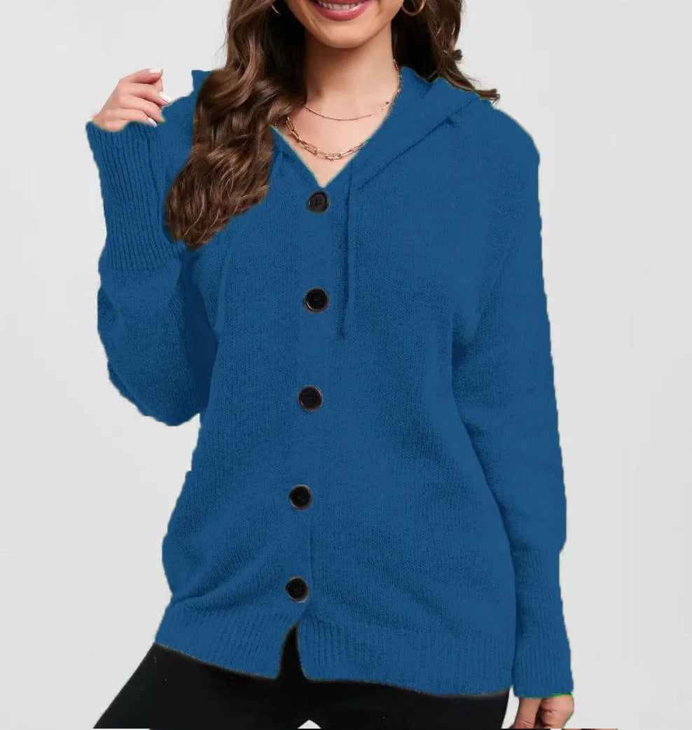 Woman wearing a thick, loose-fit grey hooded cardigan sweater with long sleeves.