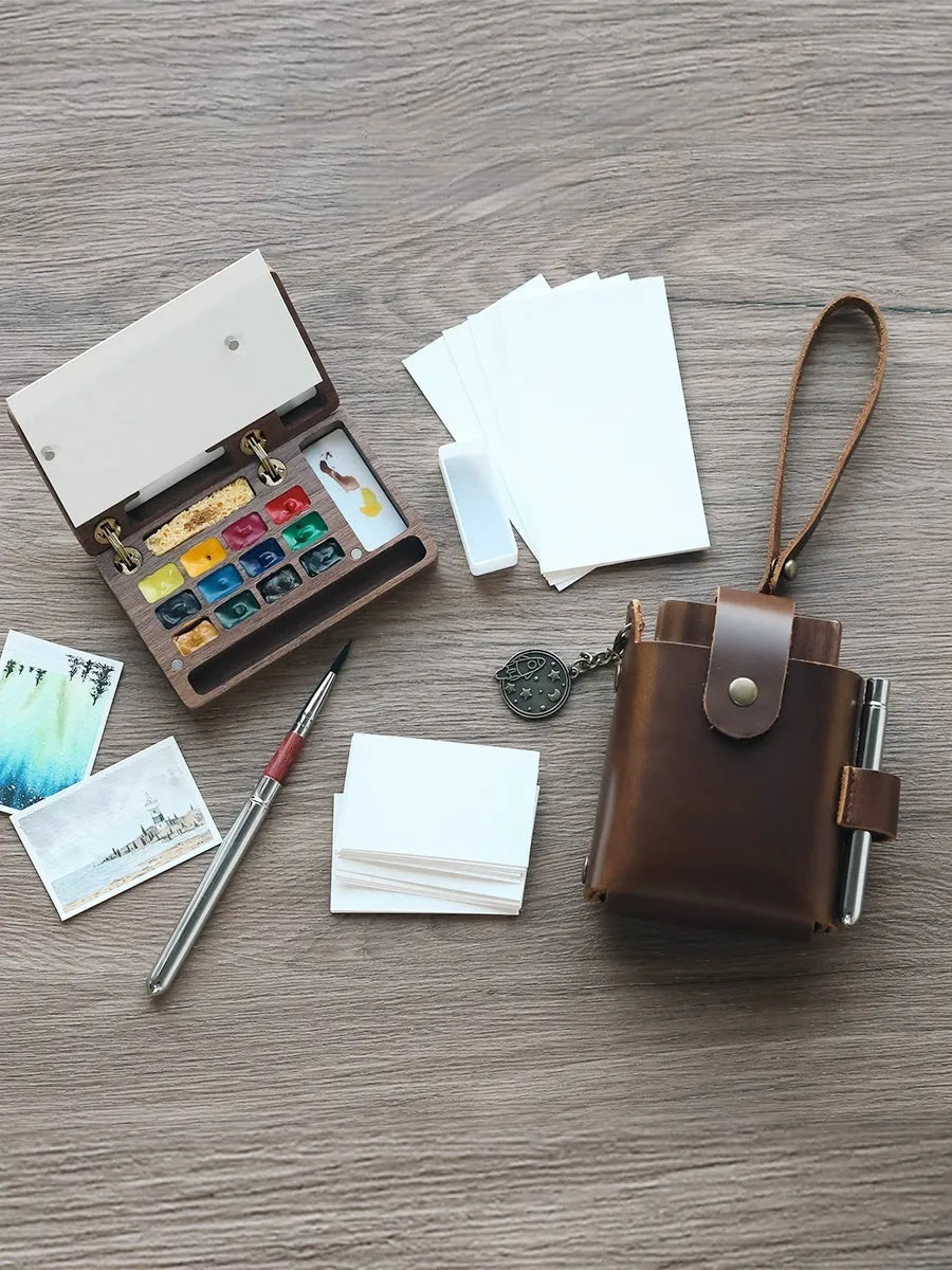 Mini wooden walnut watercolour paint box open showing pigment pans with choice of Schmincke, Holbein, Picasso, or Moonlight colour sets.