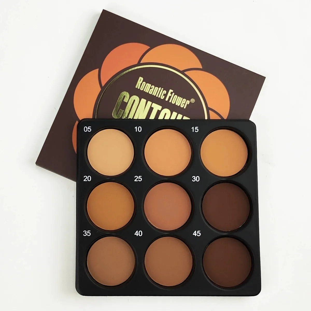 Dark matte makeup palette open showing nine colours with a repair disk