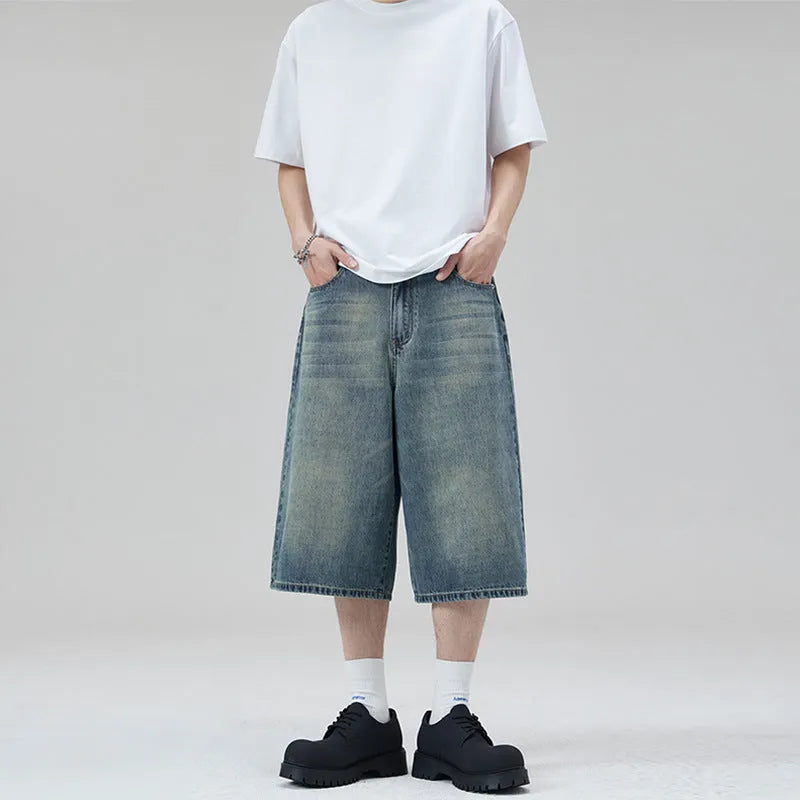 Men's light blue cotton denim shorts with a straight leg and cropped length on a hanger