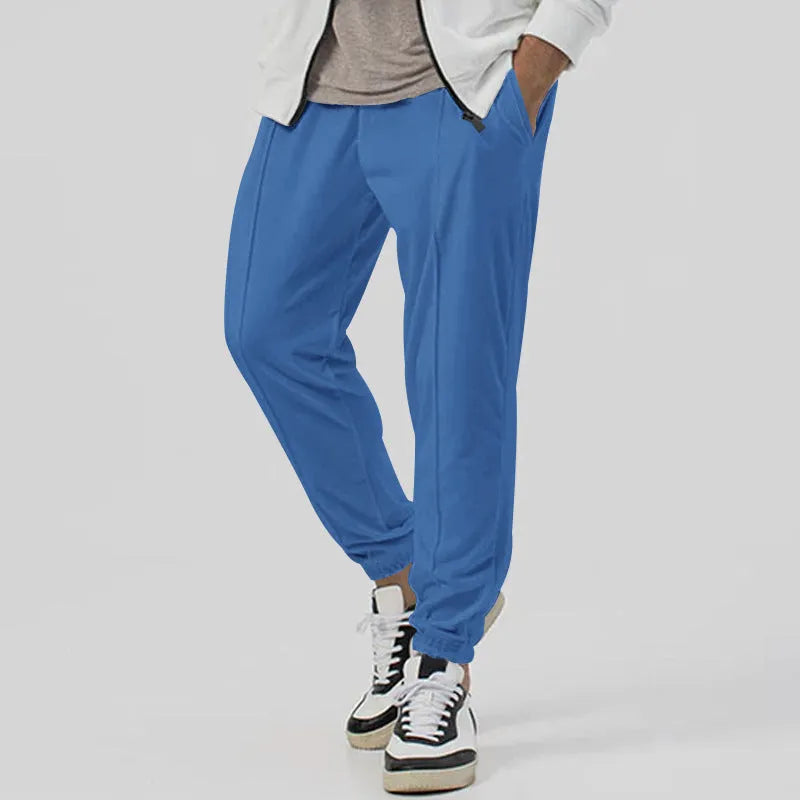 Men's grey loose-fit tapered track sweatpants with a straight leg on a neutral background.