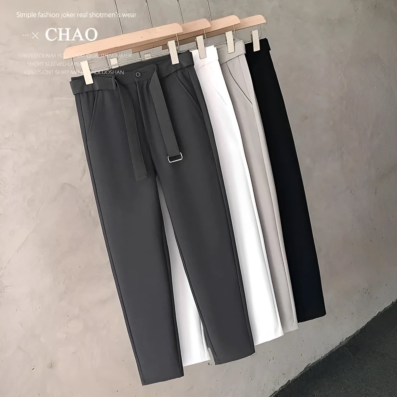 Boy wearing slim straight wool trousers in a neutral colour, showcasing the tapered fit and straight leg opening.