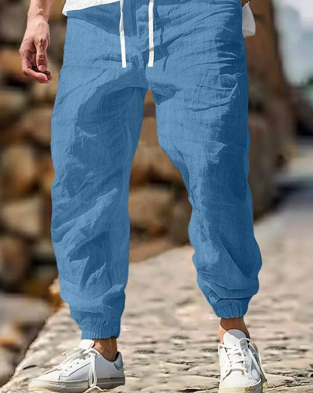 Men's straight-leg linen trousers in apricot colour with an elasticated waistband.