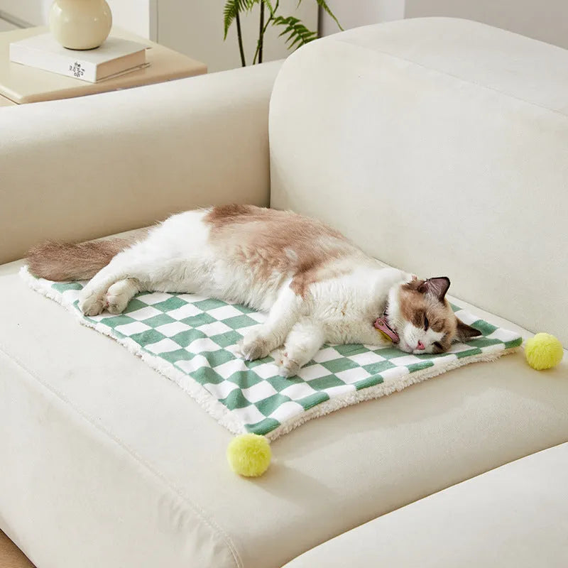 Plaid pattern pet blanket with fur ball trim on soft cotton fleece material for cats and dogs