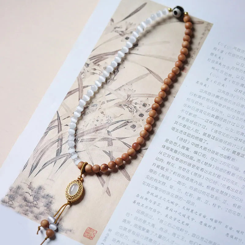 Mixed material bracelet with sandalwood double ring and opal Tibetan beads.