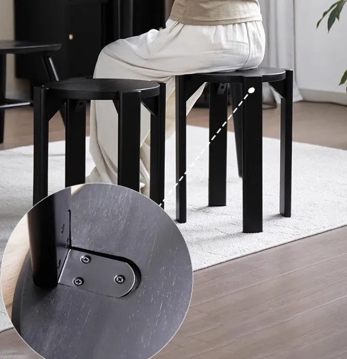 A stackable round metal dining stool in a modern style, shown in a choice of four colours.
