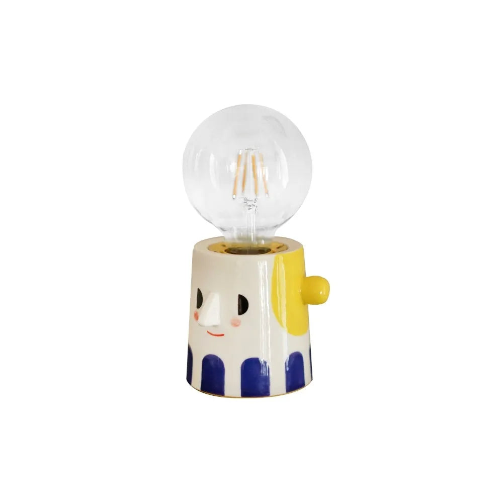 Handmade white ceramic bedside lamp with ball headlight design on wooden table
