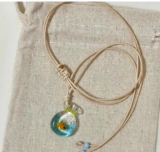 Women's necklace with Small Fish Lucky Bag glaze pendant on a cotton linen chain.