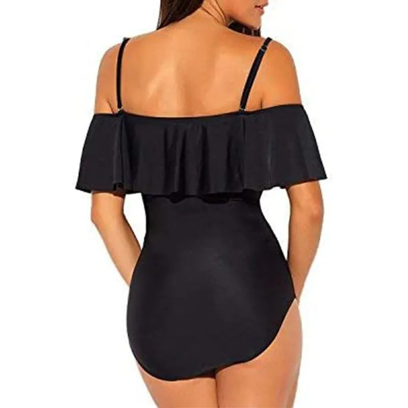 Black women's strapless one-piece swimsuit with a cut-out detail and ruffled strap.