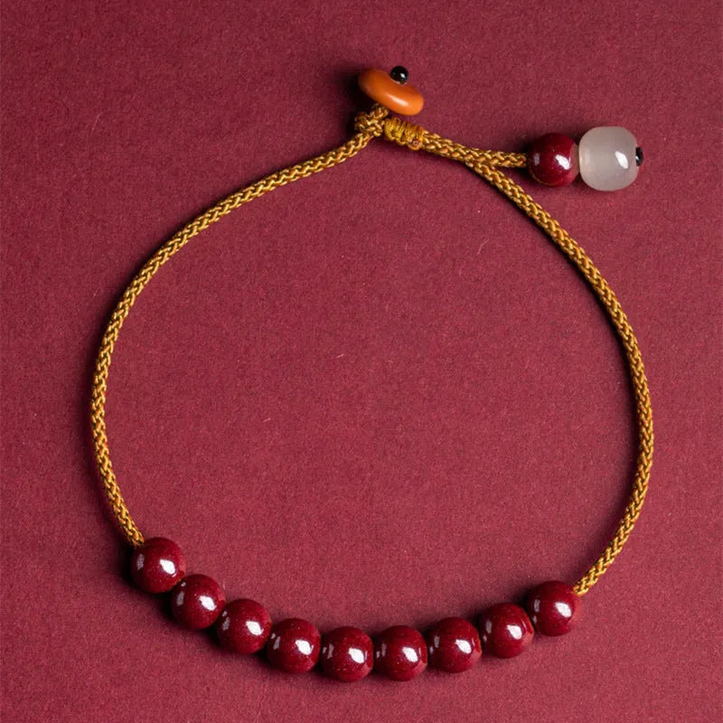 Hand-woven cinnabar geometric bracelet showing raw ore material texture and adjustable design
