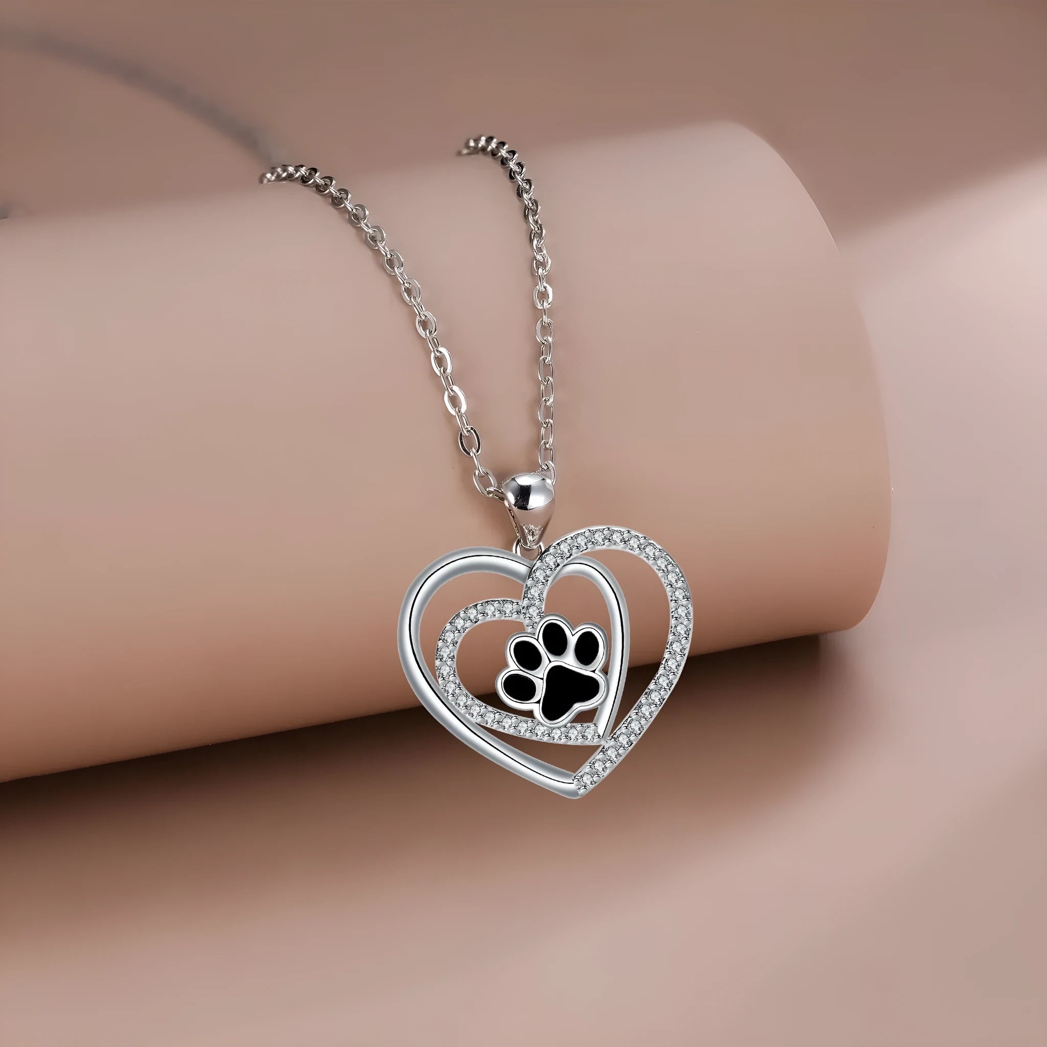 Women's copper necklace with heart-shaped dog paw print pendant on a cross chain