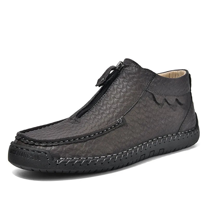 Men's black slip-on loafers with round toe and sewing thread detail on a rubber sole.
