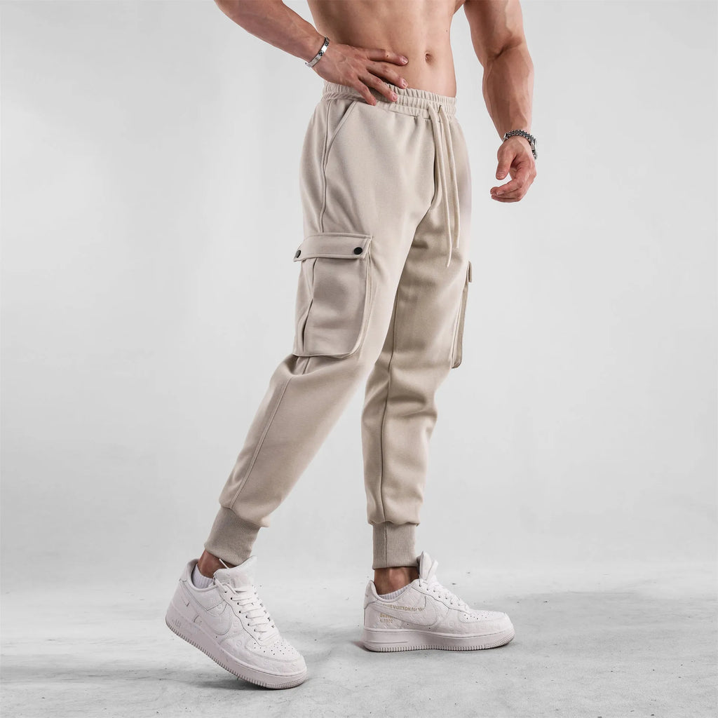 Men's loose light gray cotton trousers with ankle-tied cuffs and multiple pockets