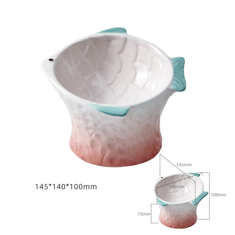 Blue fish-shaped ceramic elevated cat bowl with tilted design on a non-slip base.